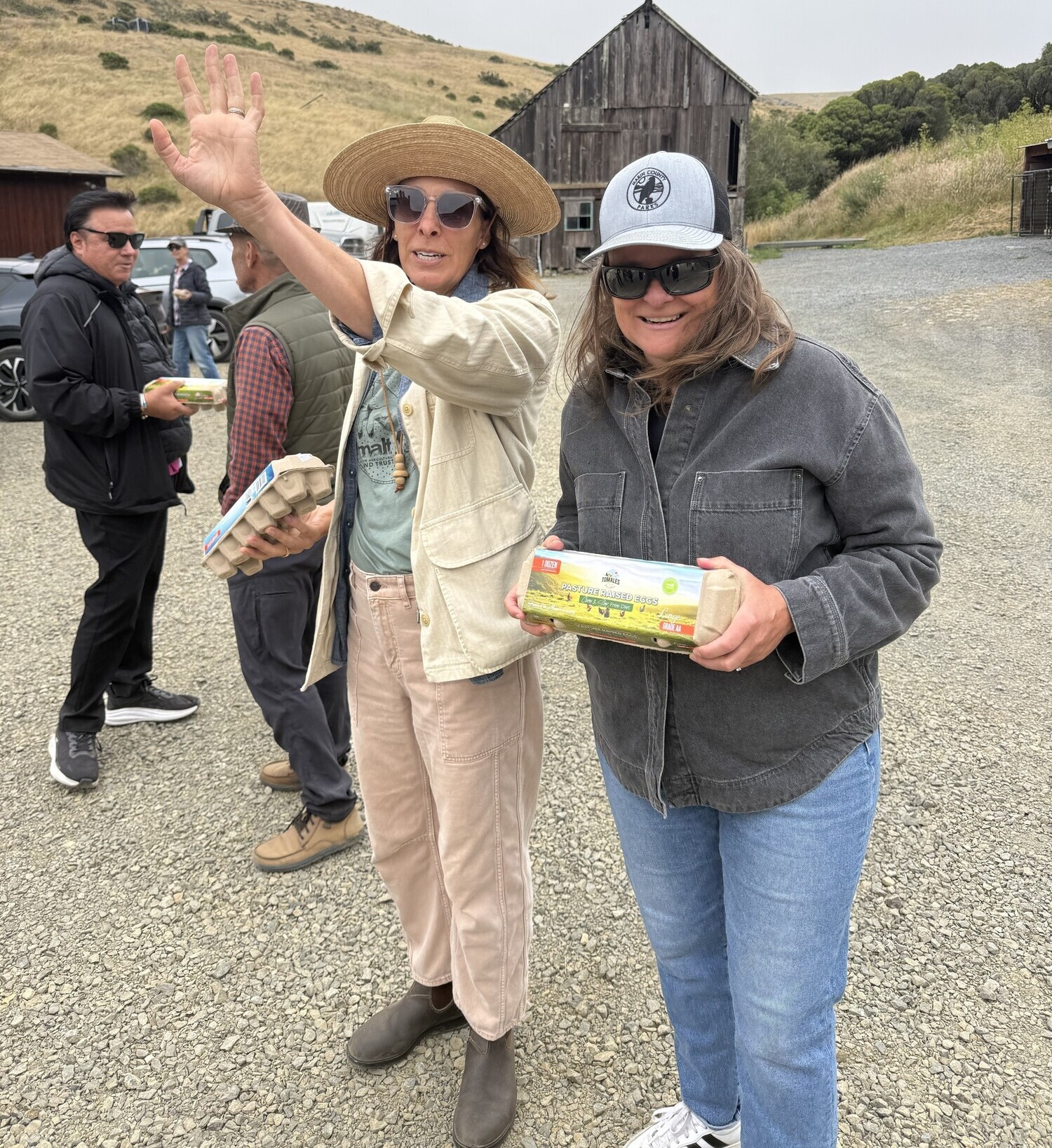 Mary and Lily holding egg cartons on ranch