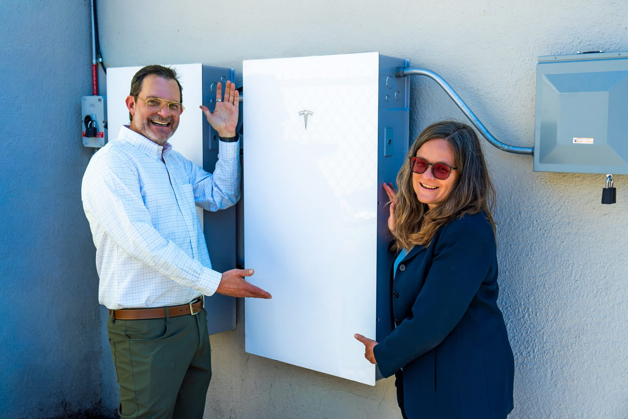 Mary and Brian standing next to battery project