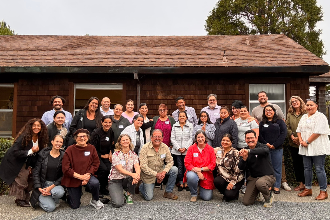 Community members pose for a photograph outside a building