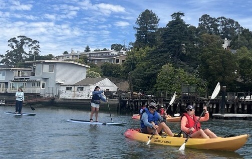Mayor Kate and Paul Navazio in a kayak and Mary on a paddleboard on the Canal