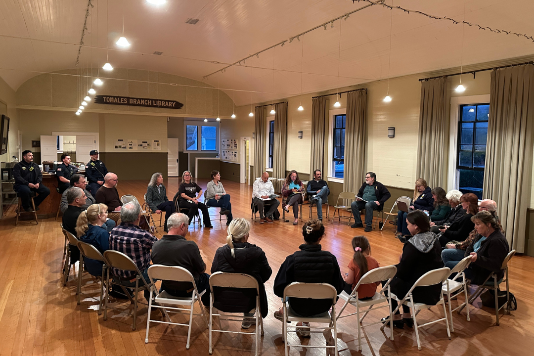 Community members sitting in a circle of chairs