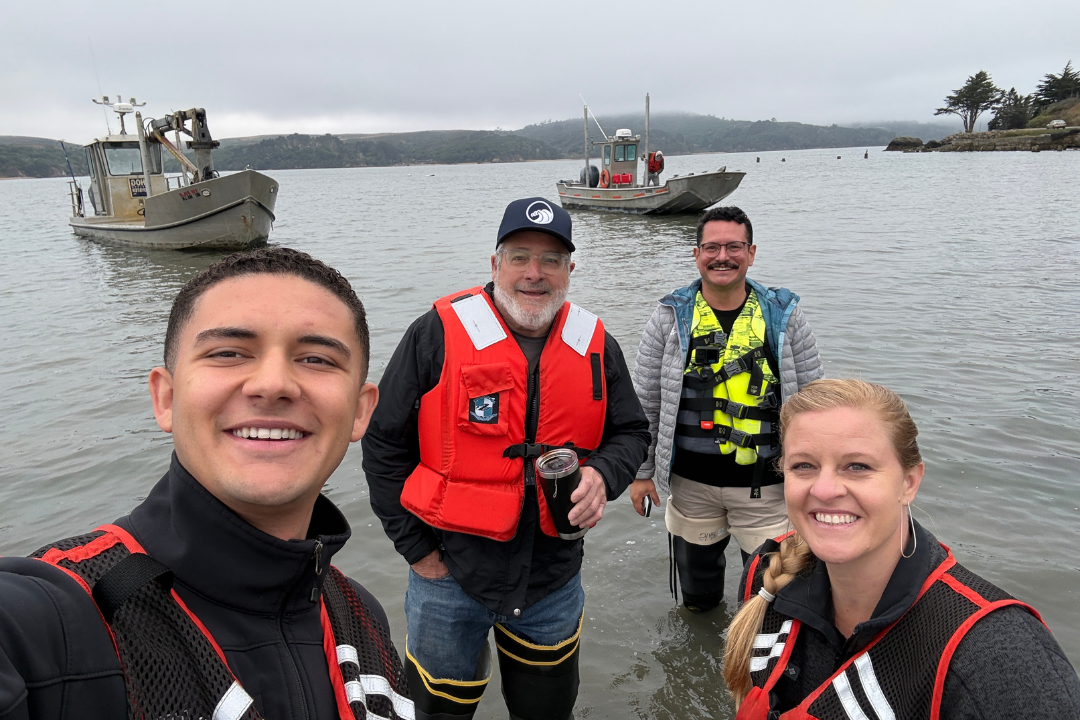 Supervisor Rodoni and his aides standing in the water along Tomales Bay