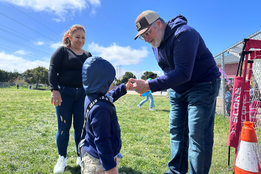 Supervisor Rodoni shaking hands with a child