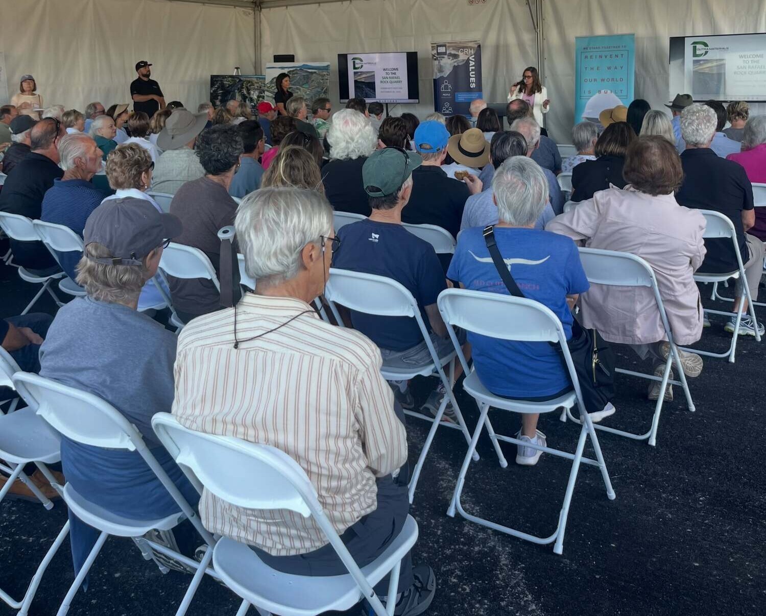 Supervisor Sackett speaking to audience under a tent at Quarry open house 