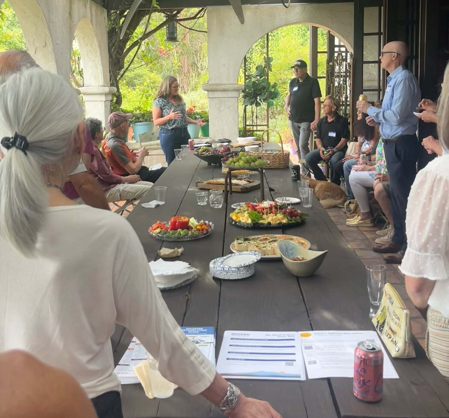 Supervisor Sackett speaking to Country Club Firewise Community gathered around a table on a patio