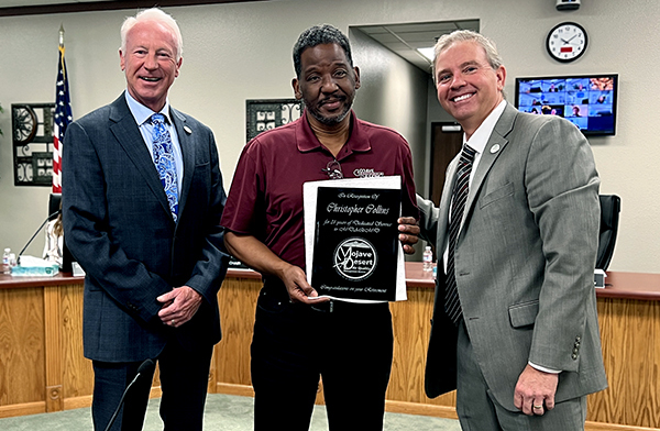 Chris Collins presented with plaque commemorating his retirement after 31 years of service to MDAQMD