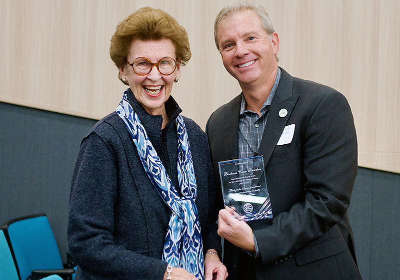Barbara Riordan, left, accepts a plaque honoring her service from MDAQMD Executive Director Brad Poiriez in January 2023
