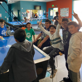 teens playing air hockey