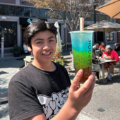 Teen holding a Boba drink.