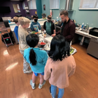 Teens participating in a cooking class.