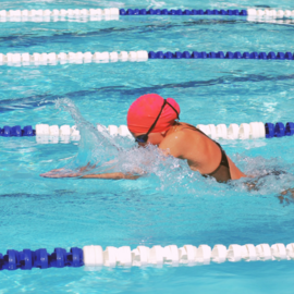 teen swimming laps in pool