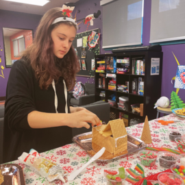 teen making a gingerbread house