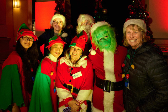 Image of people dressed as Santa Claus, The Grinch, and elves