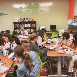 Teens painting sneakers.