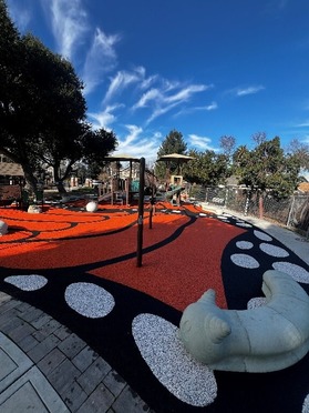 Mariposa Park image after resurfacing showing monarch butterfly wing art on the ground