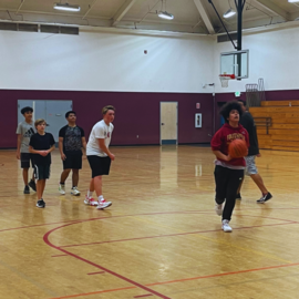Teens playing basketball