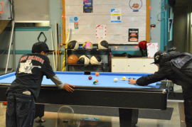 Teens playing Pool.