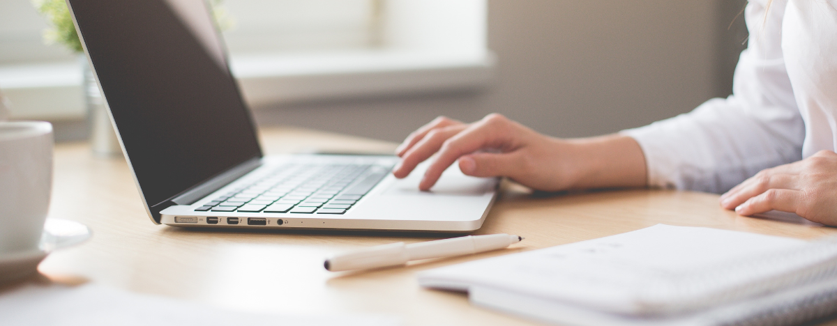 person looking at online resources through their laptop