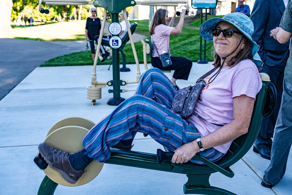 Woman using exercise equipment at Cuesta Park Fitness Court