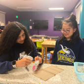 Teens making a craft.