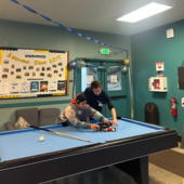 Teen and staff playing pool