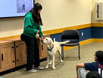Photo of the presenter and her dog providing a demonstration