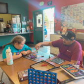 Teen and staff playing games