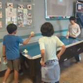 teens playing air hockey