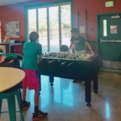 teens playing foosball