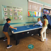 Teens playing air hockey