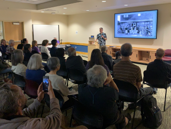 Photo of Curt Fukuda speaking to an audience during the San Jose Japantown: A Journey program