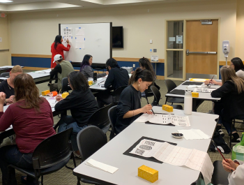 Photo of participants practicing Chinese calligraphy in the First Floor Program Room