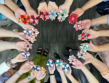 Photo of all participants holding their flower craft in a circle