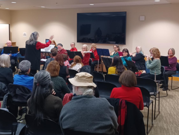 Photo of the Bel Canto Flutes ensemble performing in front of an audience at the Library