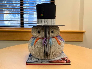 Photo of a snowman made of cut pages from books