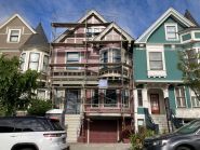 Victorian style home in San Francisco near Duboce Park with scaffolding for construction work, painting.