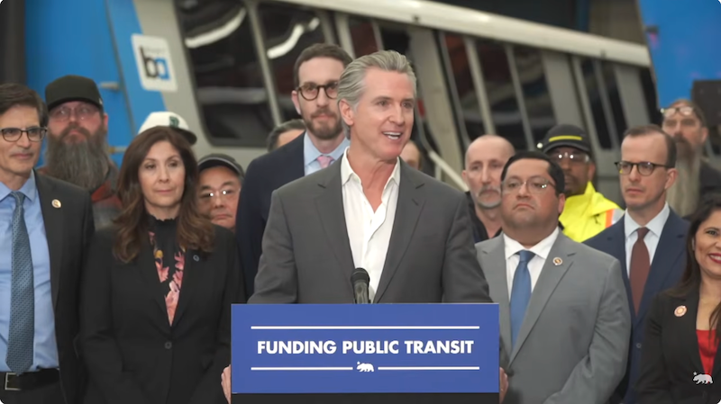 Gov. Gavin Newsom at a podium with people.