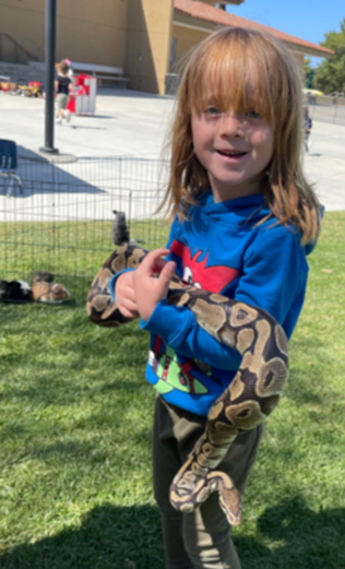 Photo of youth holding a snake