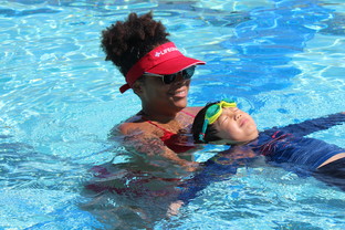 Instructor teaching swim lessons to a student