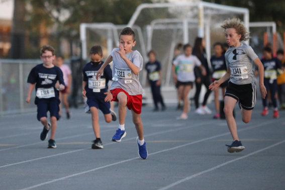 Photo of youth running on a track