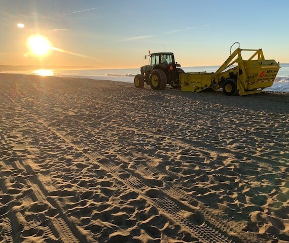 Image of truck cleaning the beach 