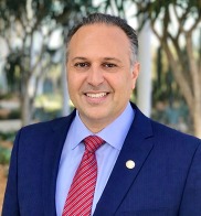 Headshot of City Manager Seimone Jurjis in front of City Hall