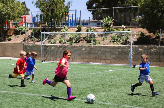 Young children playing soccer as part of a recreation department class