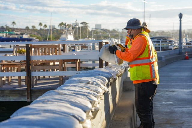 Staff building sandbag wall 