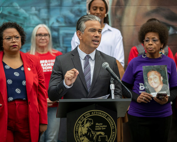 Attorney General Bonta standing at podium with four individuals standing behind him including Assemblymember Bonta and Brady California President