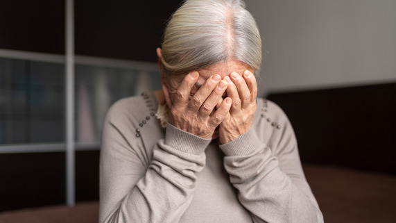 Woman with face in hands