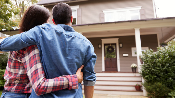 Couple in front of home