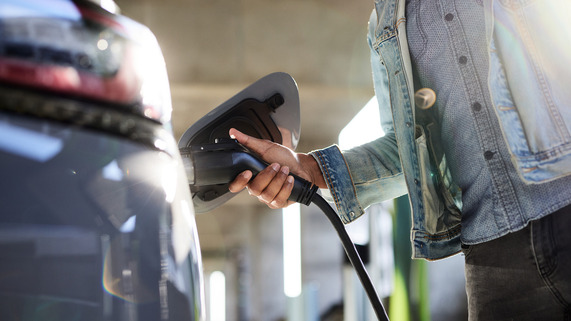 Person Charging Electric Vehicle