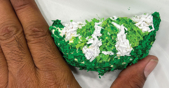 Close up of a hand with a mini citrus piñata