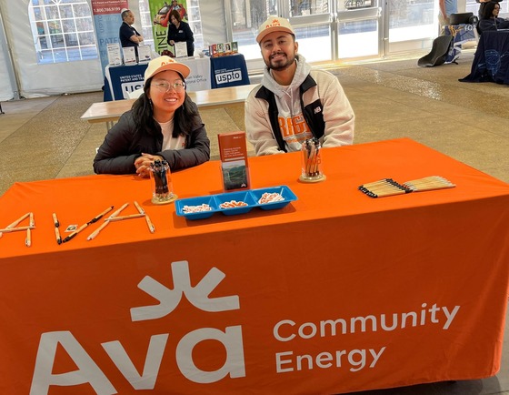 Two Ava employees table at an event
